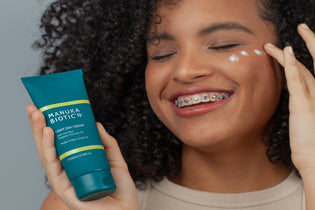  Teenager with braces applying Manuka Biotic's Light Day Cream infused with Manuka Oil for Acne free skin