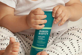  Mum applying Manuka Biotic Eczema Relief Body Lotion to her babies arms to soothe eczema and itchy dry skin