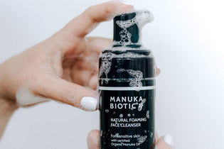 Manuka Biotic Foaming Face Cleanser in Woman's Hand with White Nail Polish