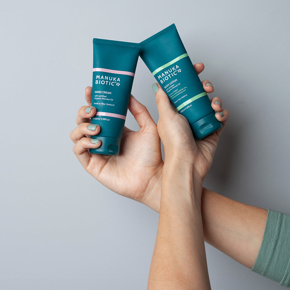  Hands holding Manuka Biotic hand cream and body lotion
