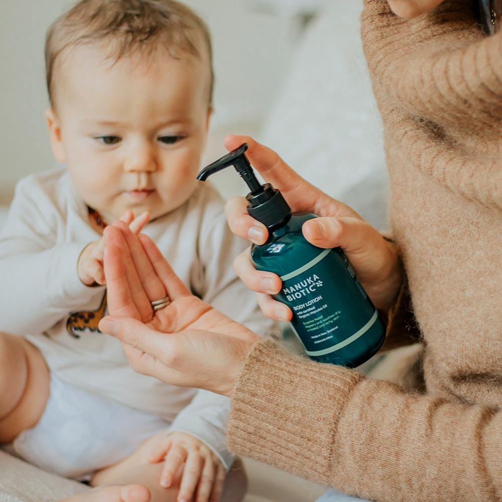  Woman about to put Manuka Biotic body lotion on her baby
