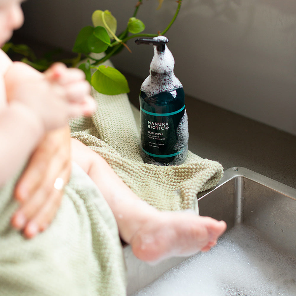  Baby being washed in a sink with Manuka Biotic body wash
